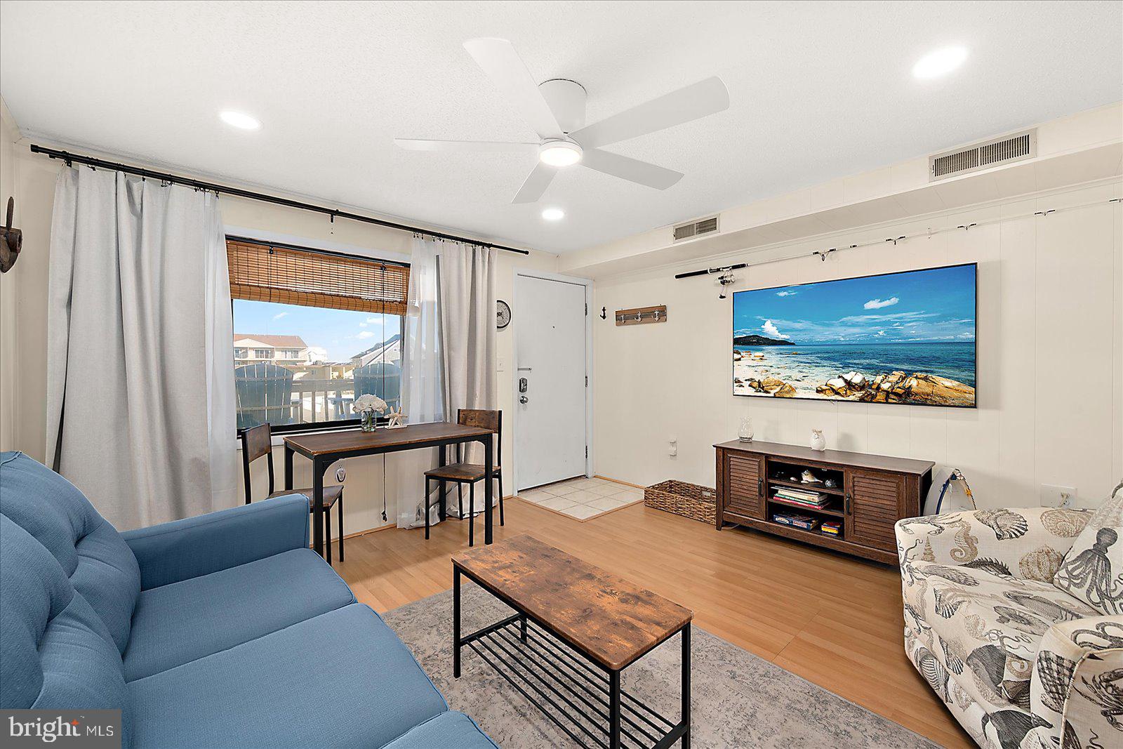 9 41st Street, Unit 320 Ocean City, MD 21842 - Photo 6 of 36 a living room with furniture and a flat screen tv
