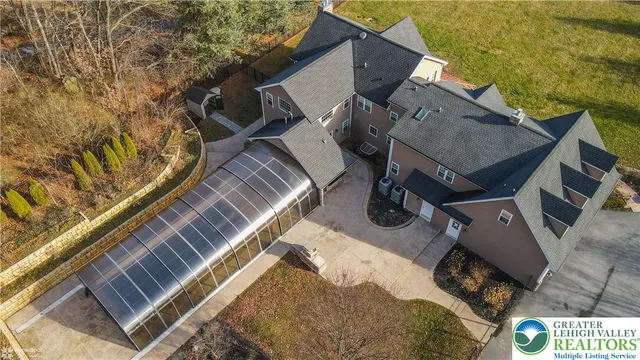 a kitchen with stainless steel appliances granite countertop a stove a sink a refrigerator and white cabinets with wooden floor