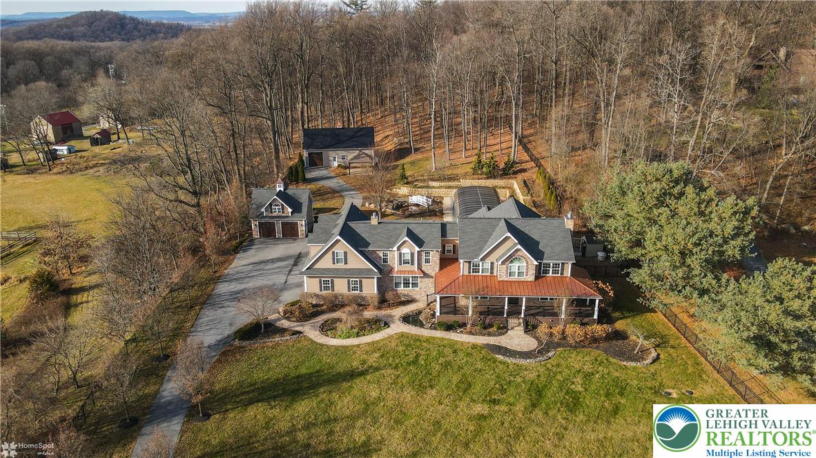 284 Walker Road Macungie, PA 18062 - Photo 2 of 99 an aerial view of a house with swimming pool and mountain view