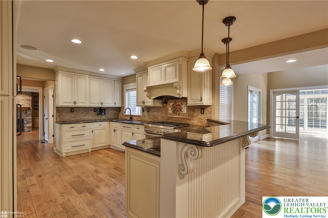 284 Walker Road Macungie, PA 18062 - Photo 39 of 99 a kitchen with stainless steel appliances granite countertop a stove a sink a refrigerator and white cabinets with wooden floor