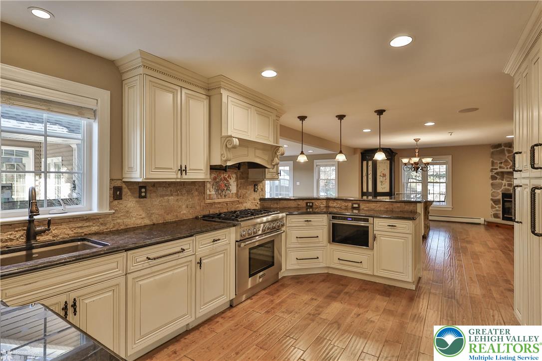 284 Walker Road Macungie, PA 18062 - Photo 43 of 99 a large kitchen with stainless steel appliances lots of white cabinets and a granite counter tops