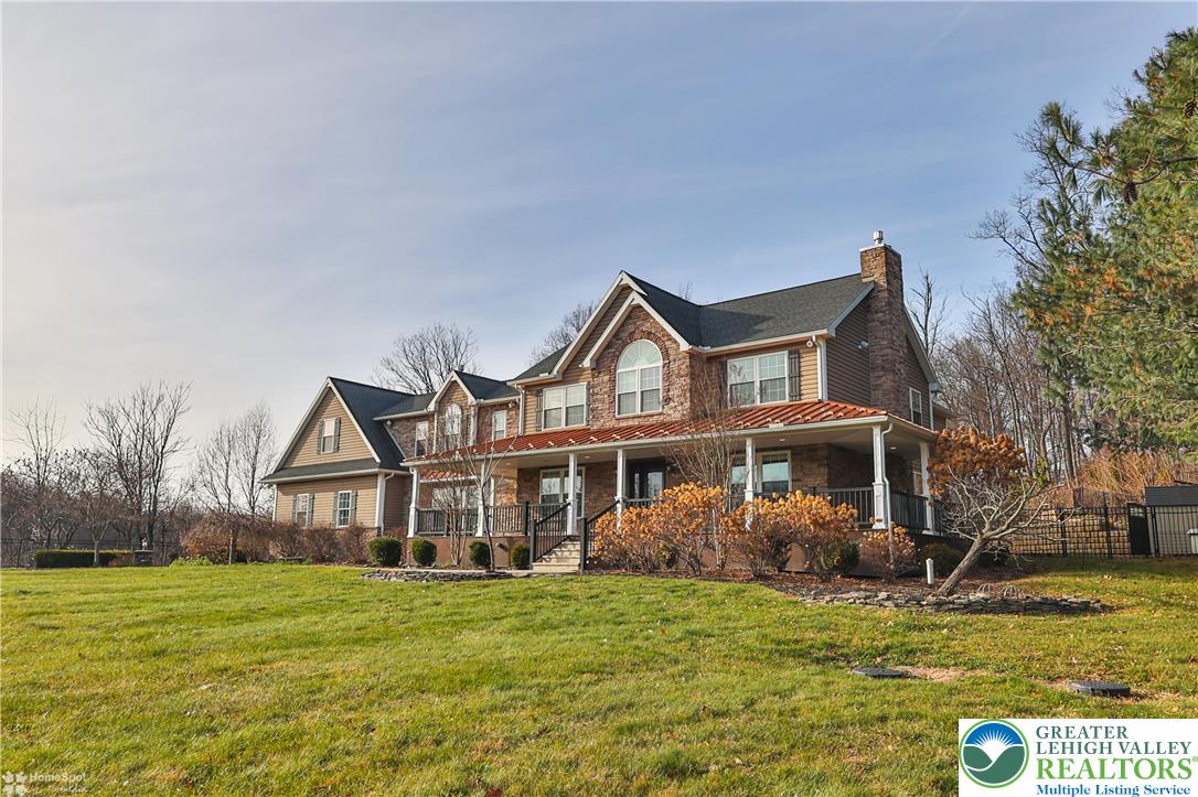 284 Walker Road Macungie, PA 18062 - Photo 6 of 99 a view of a house with a big yard and large trees