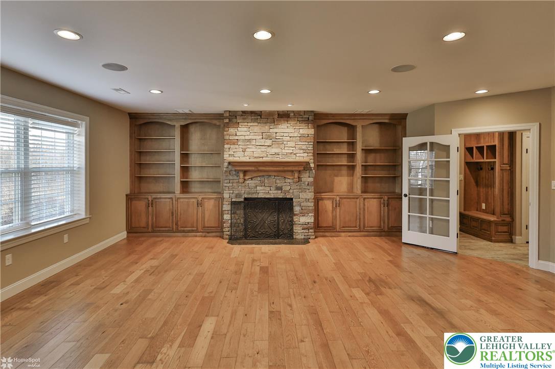 284 Walker Road Macungie, PA 18062 - Photo 65 of 99 an empty room with wooden floor fireplace and windows