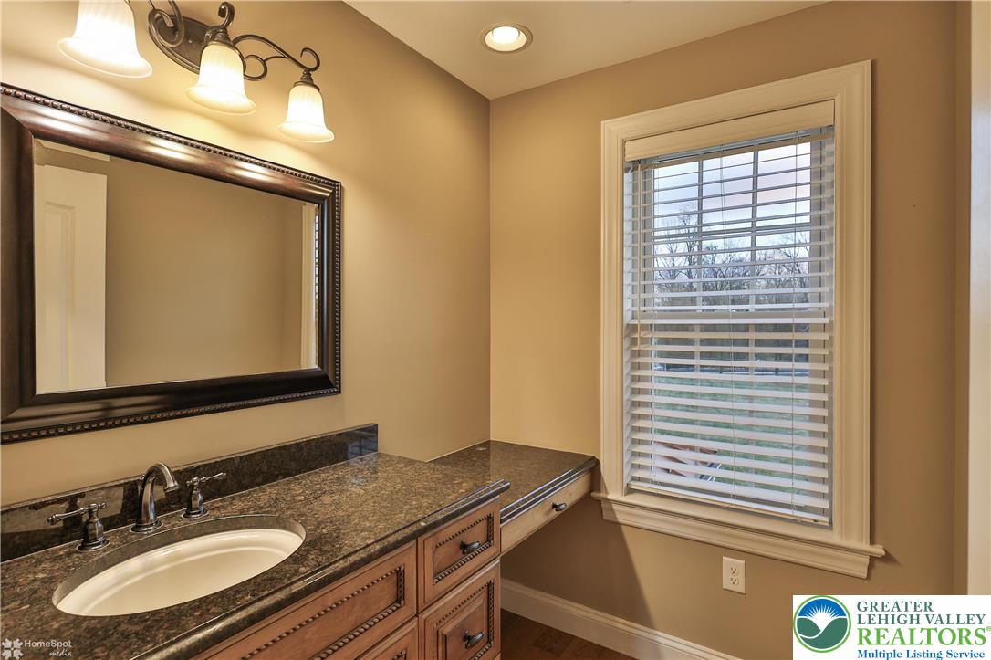 284 Walker Road Macungie, PA 18062 - Photo 77 of 99 a bathroom with a granite countertop sink and a mirror