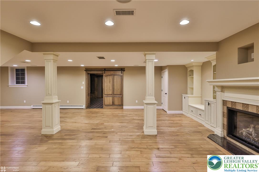 284 Walker Road Macungie, PA 18062 - Photo 89 of 99 a view of empty room with wooden floor and fireplace