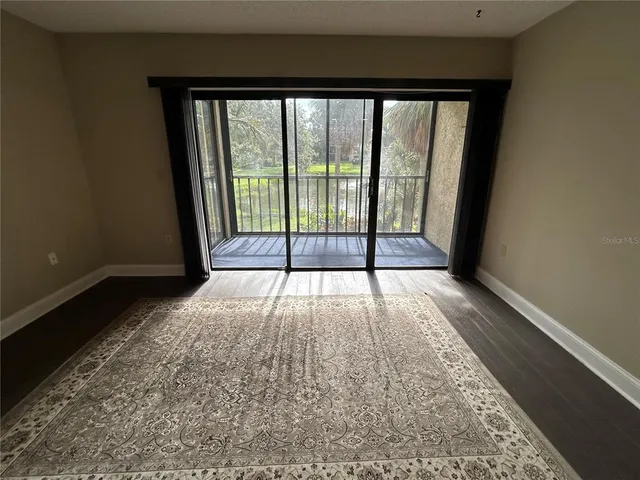 a view of hallway with wooden floor