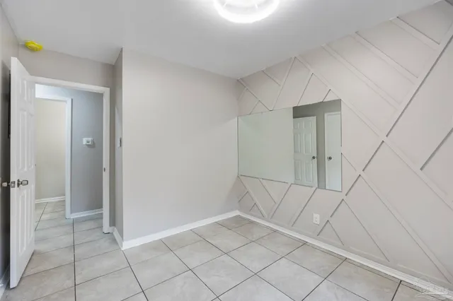 a bathroom with a granite countertop toilet and a sink