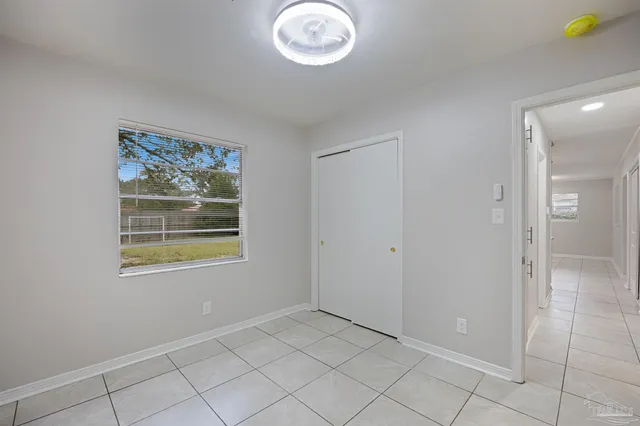 a backyard of a house with barbeque oven and table