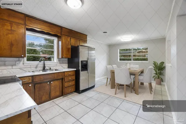 a kitchen with stainless steel appliances granite countertop a refrigerator a sink a stove and white cabinets