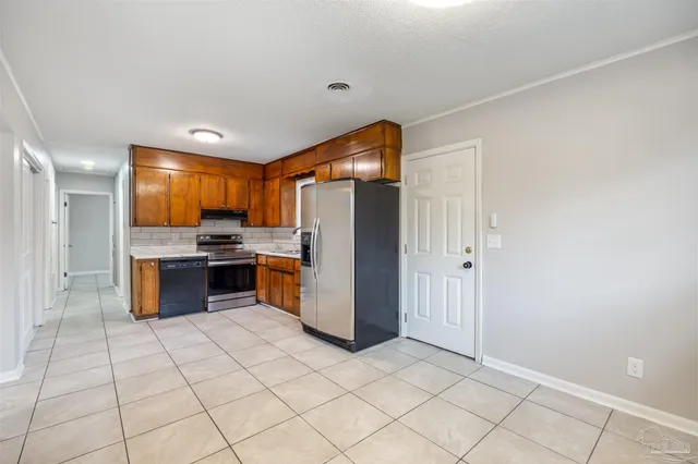 a kitchen with stainless steel appliances granite countertop a refrigerator and a stove