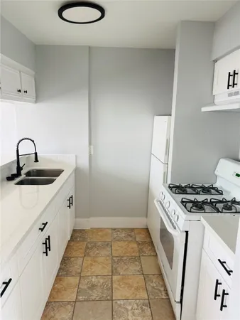 a kitchen with a sink and a stove