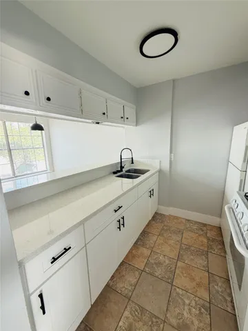 a kitchen with a sink and cabinets