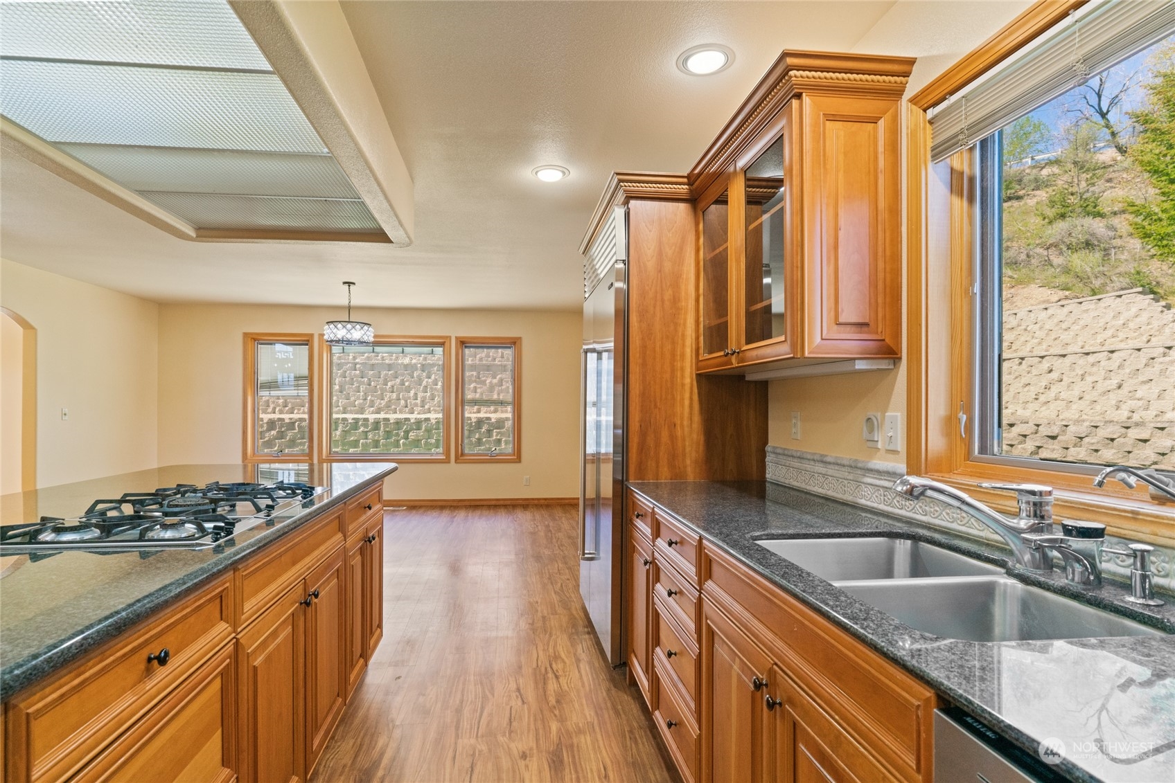 8 Valley View Park Road Omak, WA 98841 - Photo 15 of 40 a kitchen with stainless steel appliances granite countertop a sink a stove and a wooden cabinets