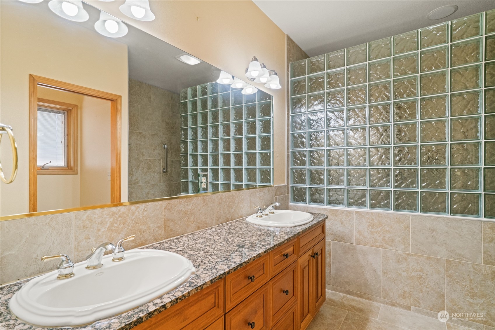 8 Valley View Park Road Omak, WA 98841 - Photo 24 of 40 a bathroom with a granite countertop sink and mirror