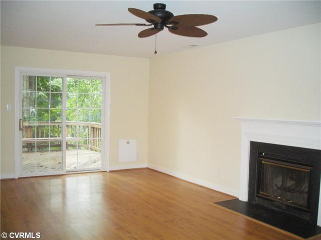 Living Room - View of spacious living area with fireplace.  Sliding glass doors lead to large deck that overlooks private backyard