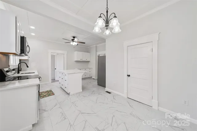 a view of a kitchen with sink and stainless steel appliances