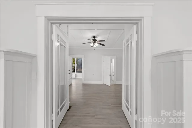 a view of a hallway view with a chandelier