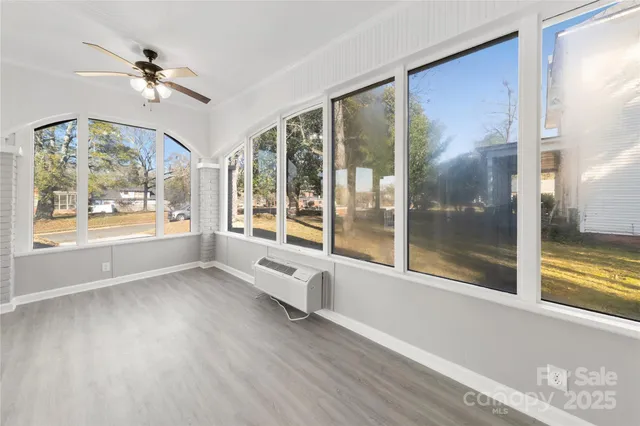 a view of an entryway with wooden floor and a ceiling fan