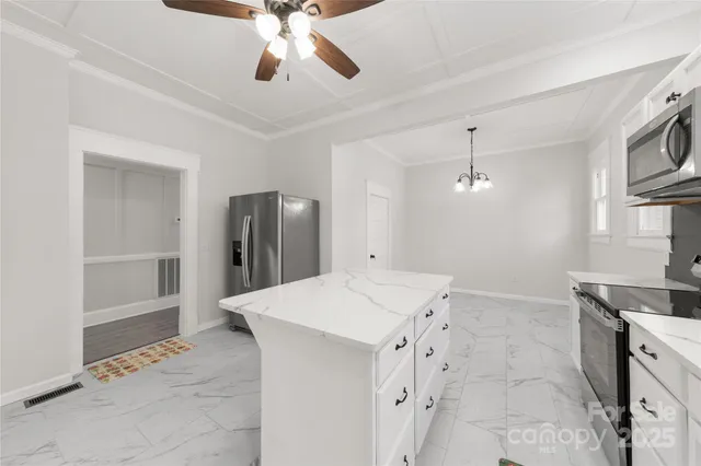 a view of kitchen with refrigerator and cabinets