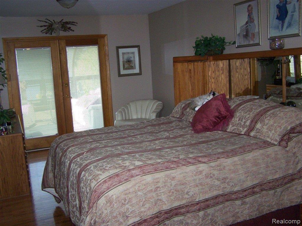 2781 Earl Lake Road Howell, MI 48843 - Photo 9 of 15 MASTER BEDROOM LEADS TO SUNROOM