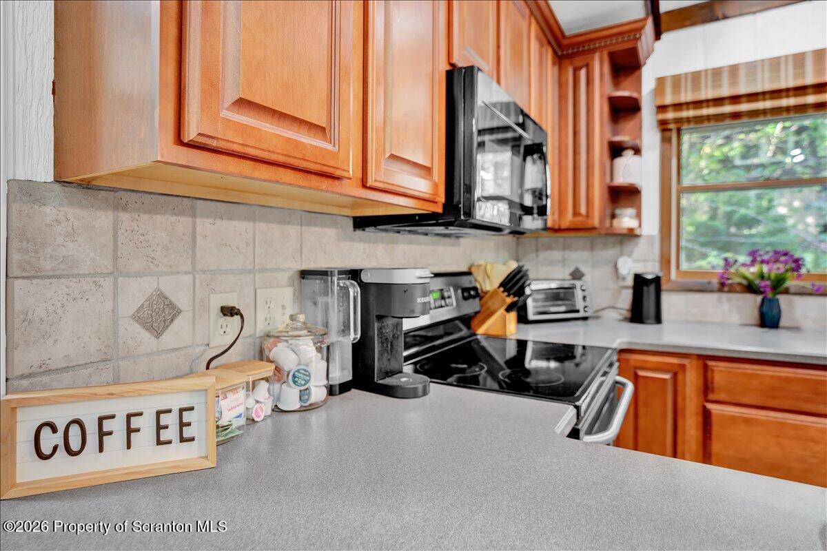 58 Sheffick Road Gouldsboro, PA 18424 - Photo 13 of 44 a kitchen with blue cabinets and a sink