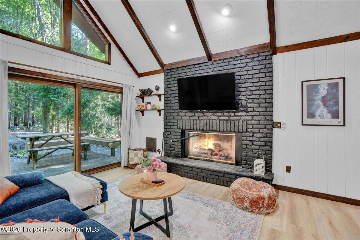 58 Sheffick Road Gouldsboro, PA 18424 - Photo 4 of 44 a living room with furniture a flat screen tv and a fireplace