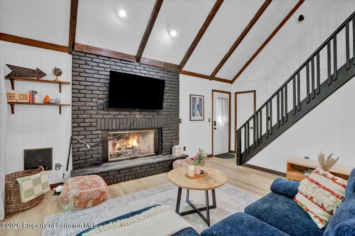 58 Sheffick Road Gouldsboro, PA 18424 - Photo 5 of 44 a living room with furniture a flat screen tv and a fireplace