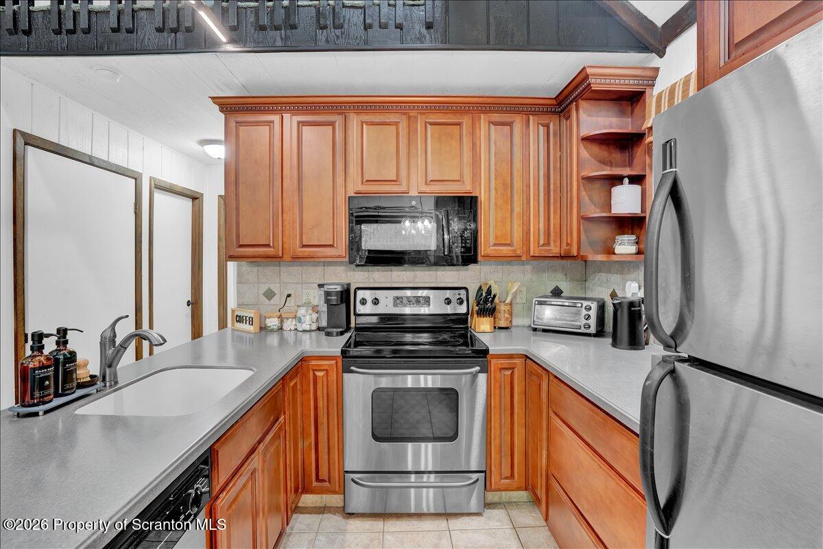 58 Sheffick Road Gouldsboro, PA 18424 - Photo 9 of 44 a kitchen with stainless steel appliances a stove sink microwave and cabinets