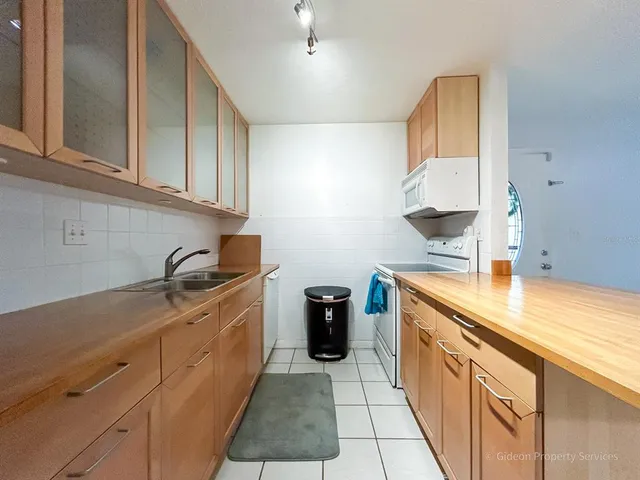 a kitchen with stainless steel appliances granite countertop a sink and cabinets