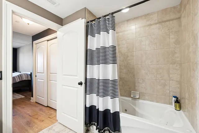 a bathroom with a bathtub and a shower