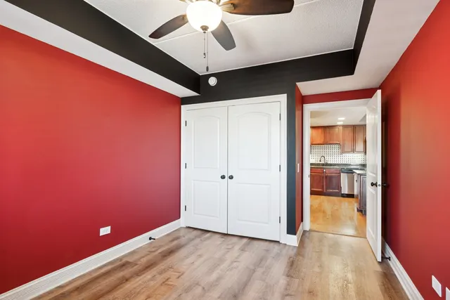 a view of empty room with wooden floor