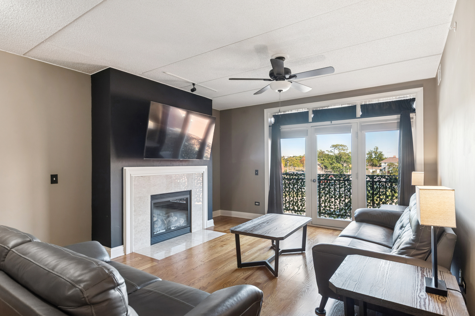 310 South Main Street, Unit 314 Lombard, IL 60148 - Photo 2 of 18 a living room with furniture a fireplace and a flat screen tv