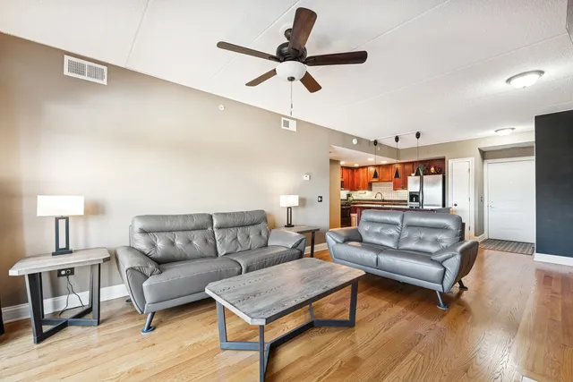 a living room with furniture and a wooden floor
