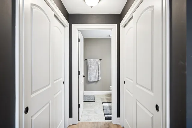 a bathroom with a glass shower door and mirror