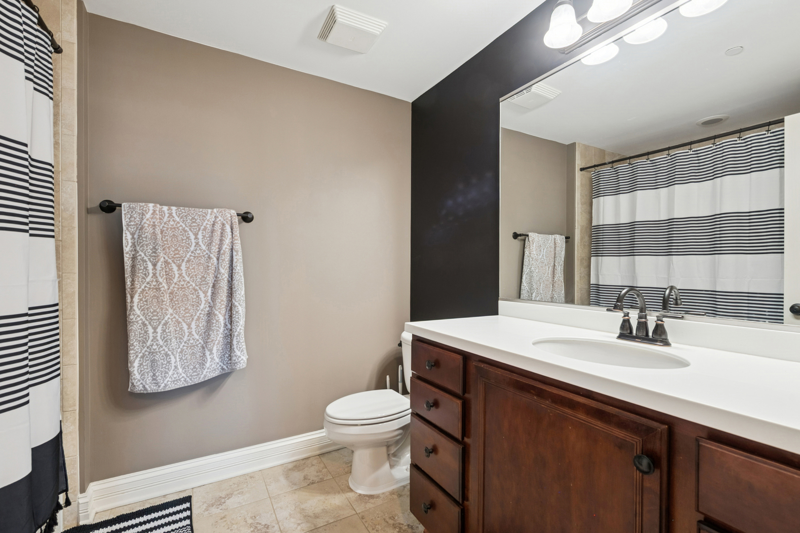 310 South Main Street, Unit 314 Lombard, IL 60148 - Photo 10 of 18 a bathroom with a sink a toilet and mirror