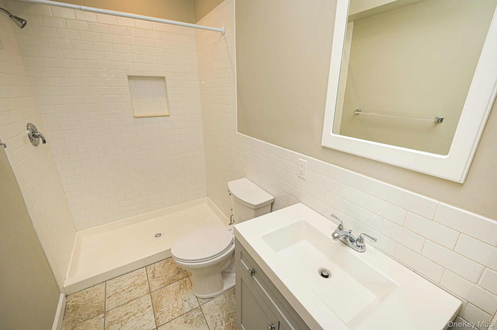 463-465 Main Street, Unit A Islip, NY 11751 - Photo 12 of 15 a bathroom with a sink a toilet and shower