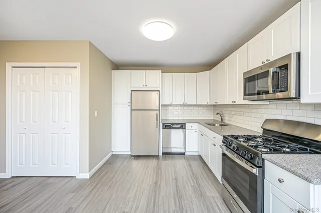 a kitchen with a sink stove and refrigerator