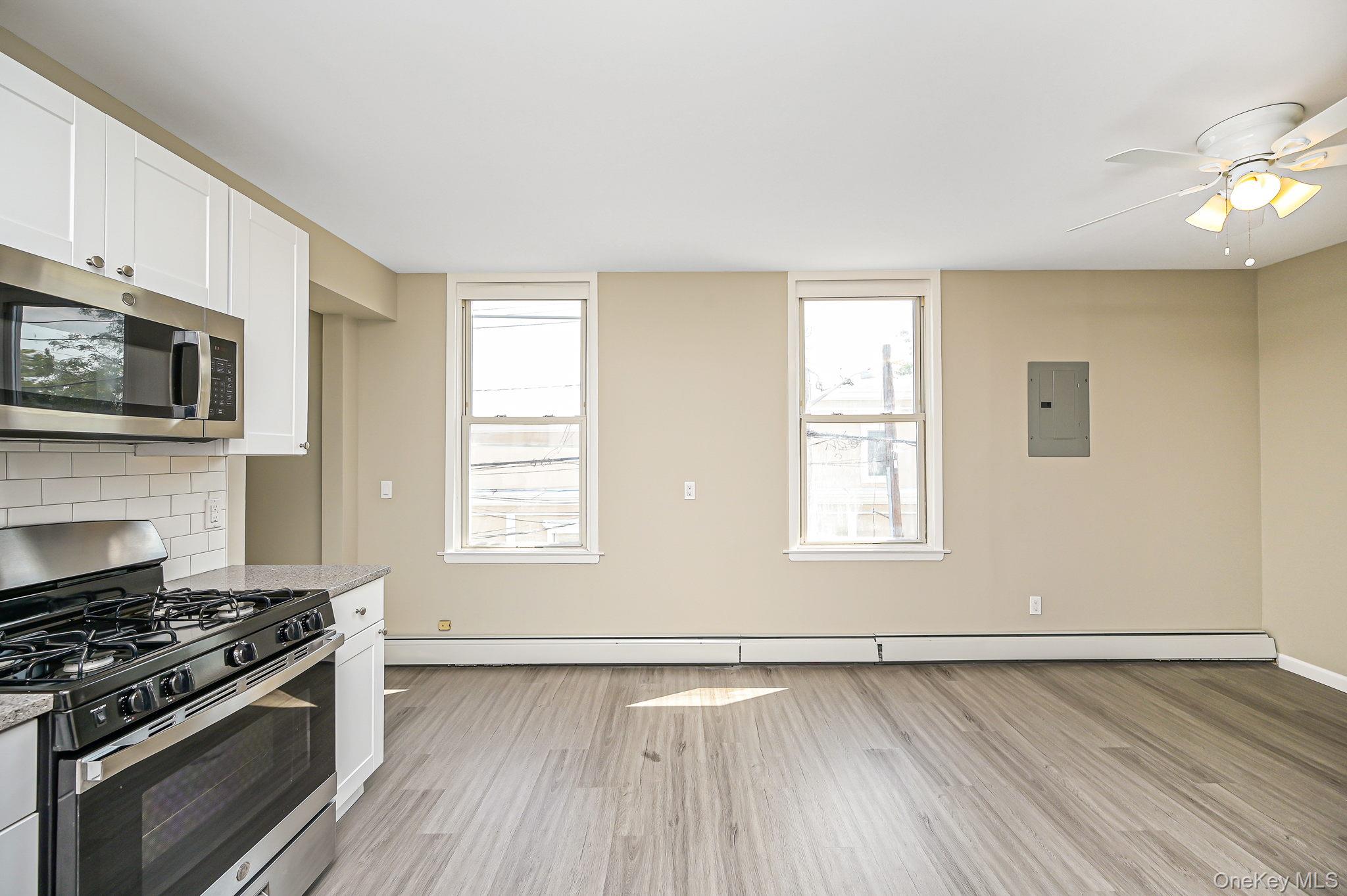 463-465 Main Street, Unit A Islip, NY 11751 - Photo 5 of 15 a view of an empty room with wooden floor and a window
