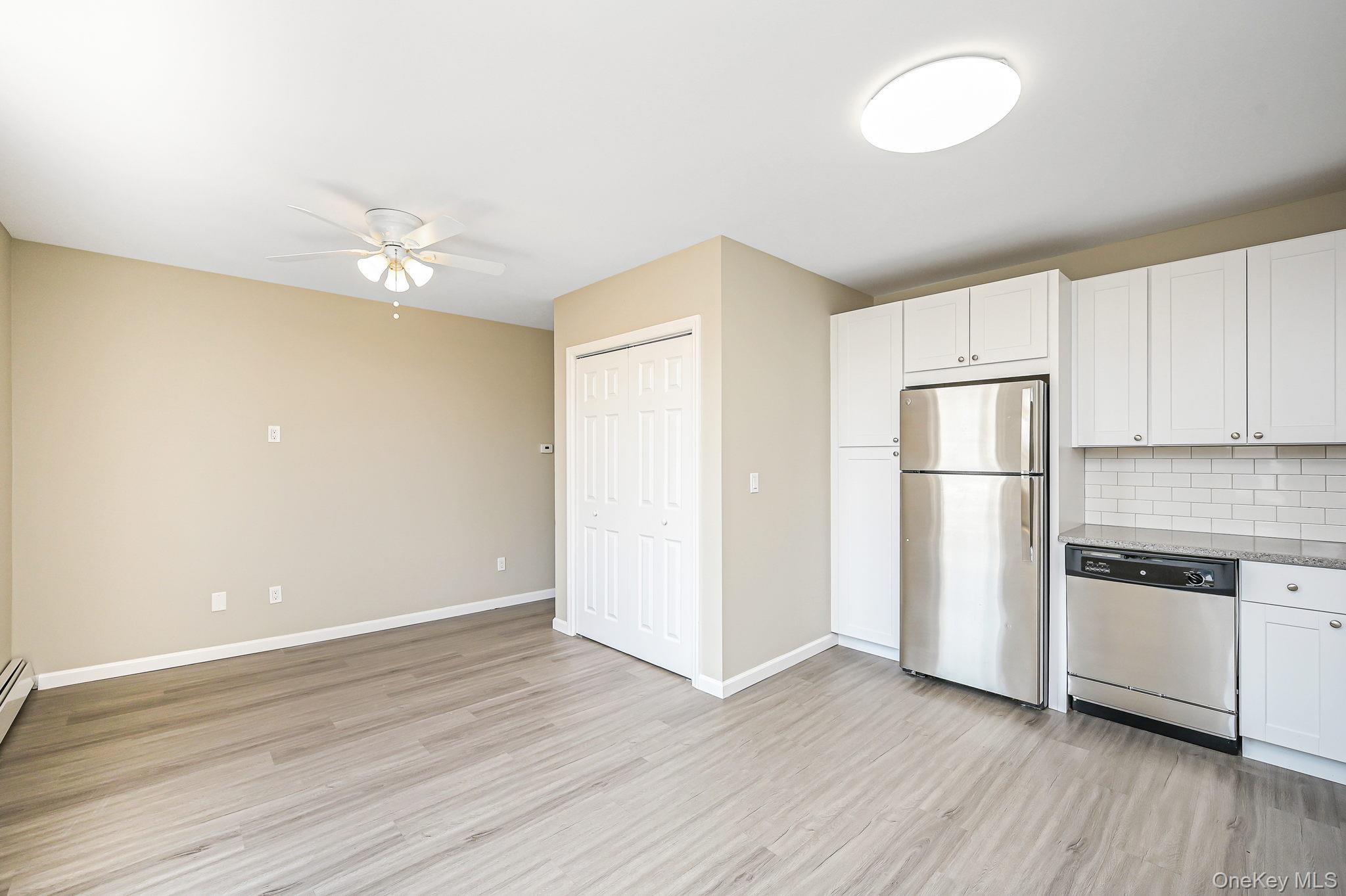 463-465 Main Street, Unit A Islip, NY 11751 - Photo 7 of 15 a view of a kitchen with wooden floor and a refrigerator