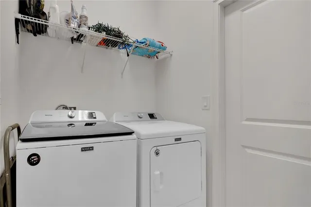 an aerial view of a residential houses with outdoor space and city view