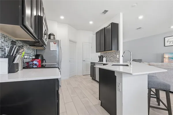a view of a dining room with furniture a chandelier and wooden floor