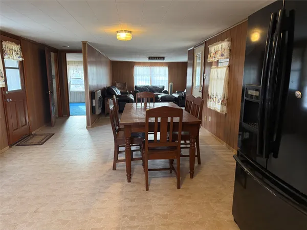 a large kitchen with a table and chairs in it