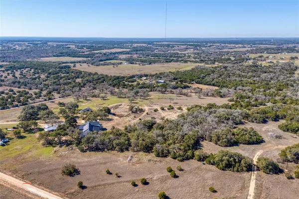 an aerial view of a house with a yard