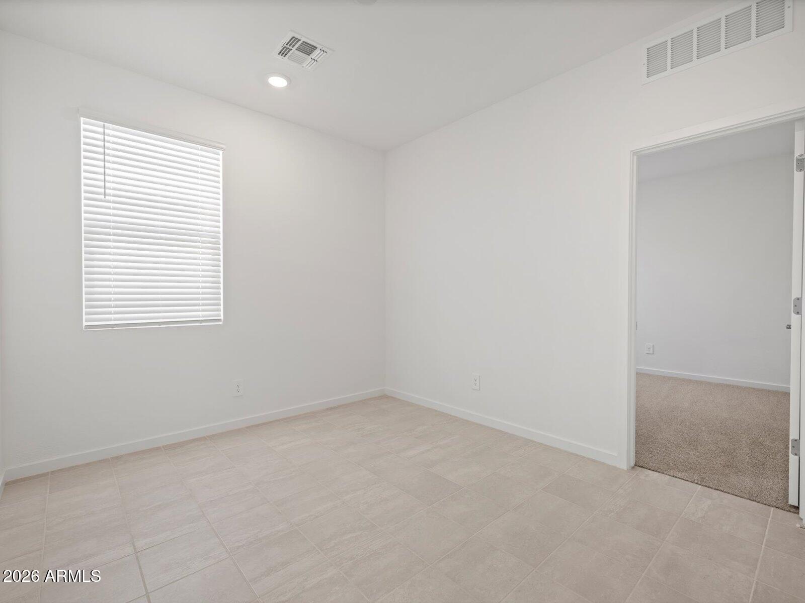 8936 South 244th Lane Buckeye, AZ 85326 - Photo 14 of 45 an empty room with a window