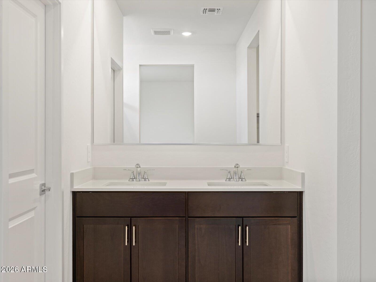 8936 South 244th Lane Buckeye, AZ 85326 - Photo 23 of 45 a bathroom with a sink and a mirror