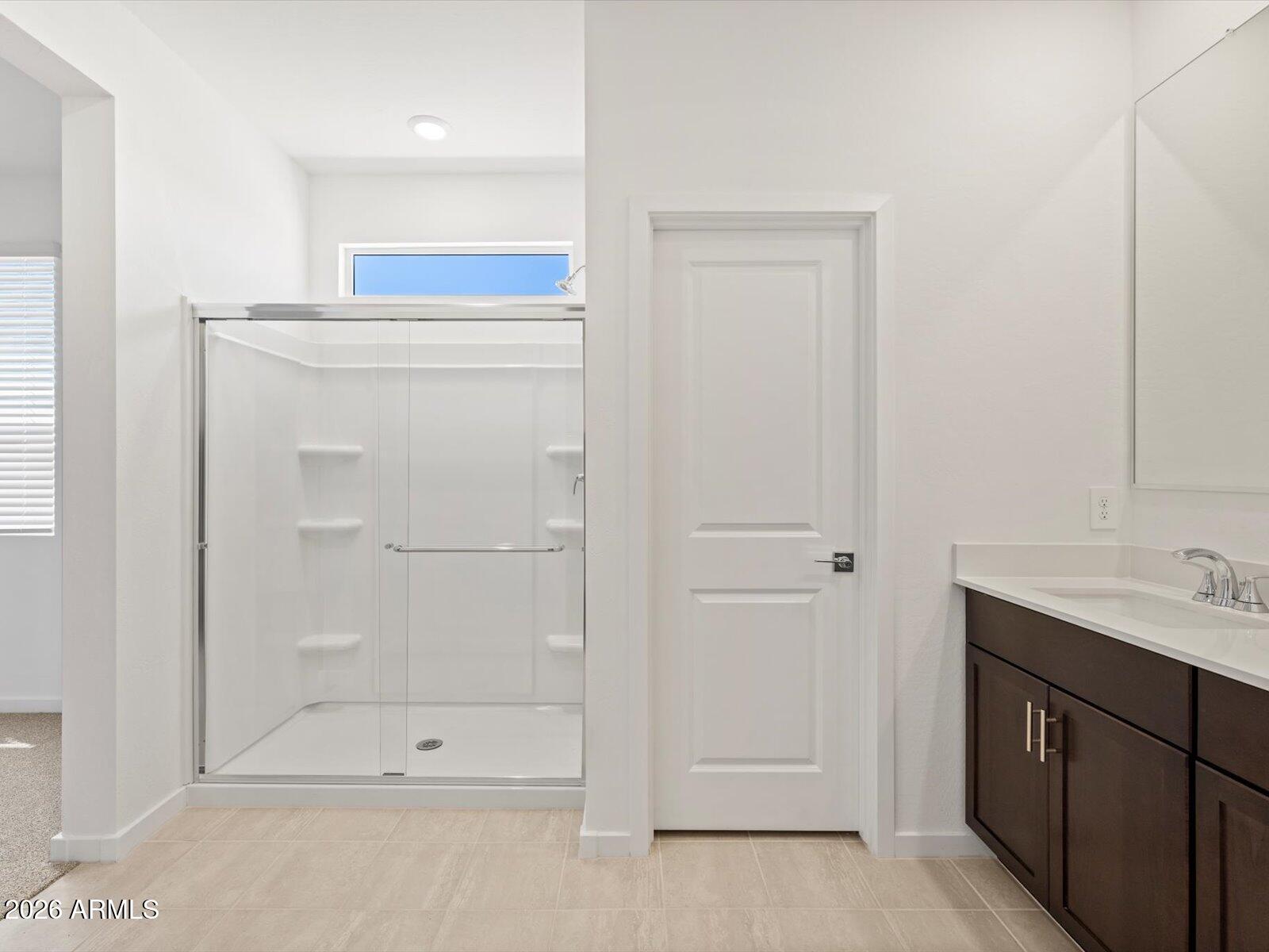 8936 South 244th Lane Buckeye, AZ 85326 - Photo 25 of 45 a bathroom with a shower sink and mirror