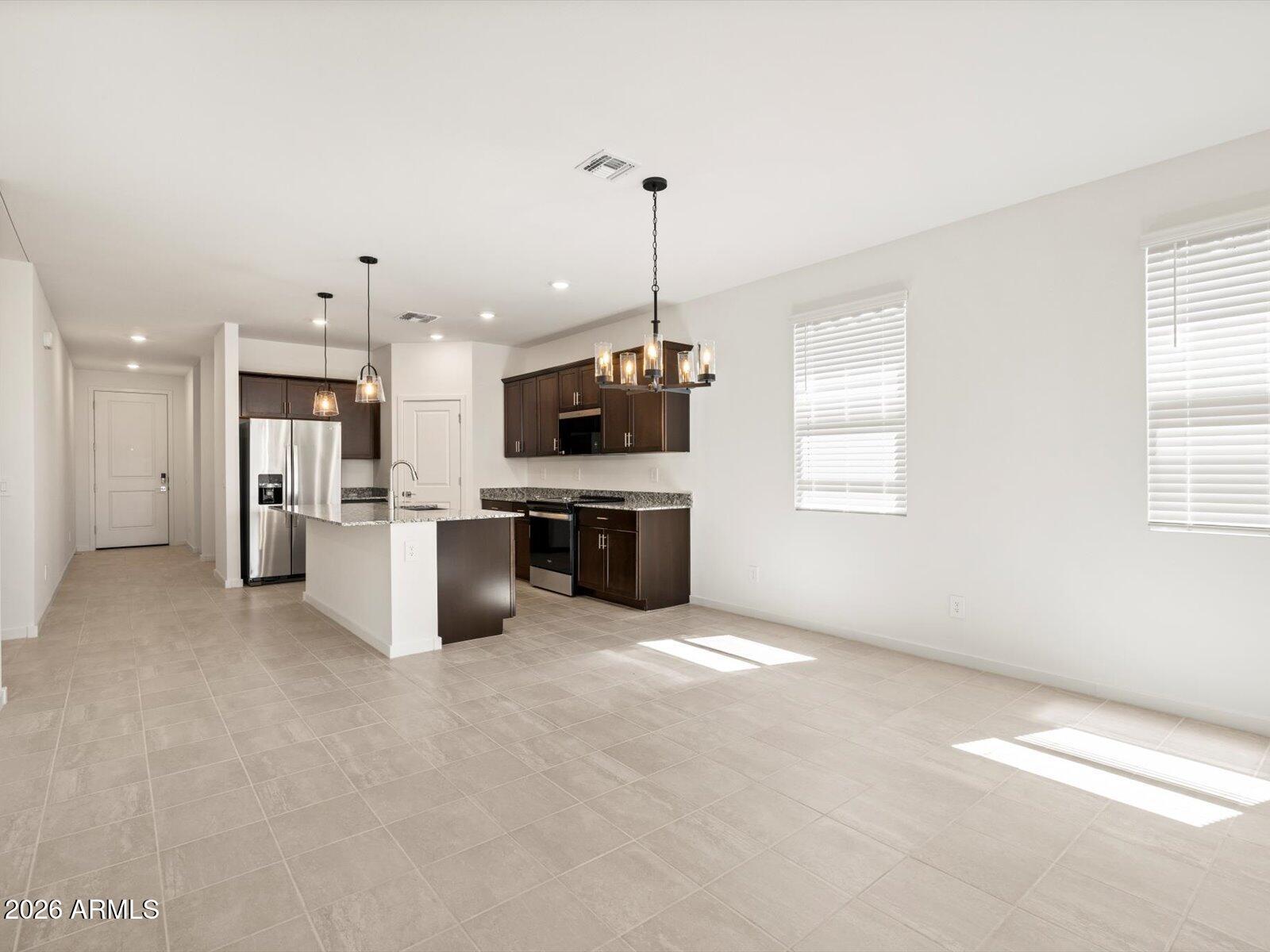 8936 South 244th Lane Buckeye, AZ 85326 - Photo 37 of 45 a view of a kitchen with a sink microwave and cabinets