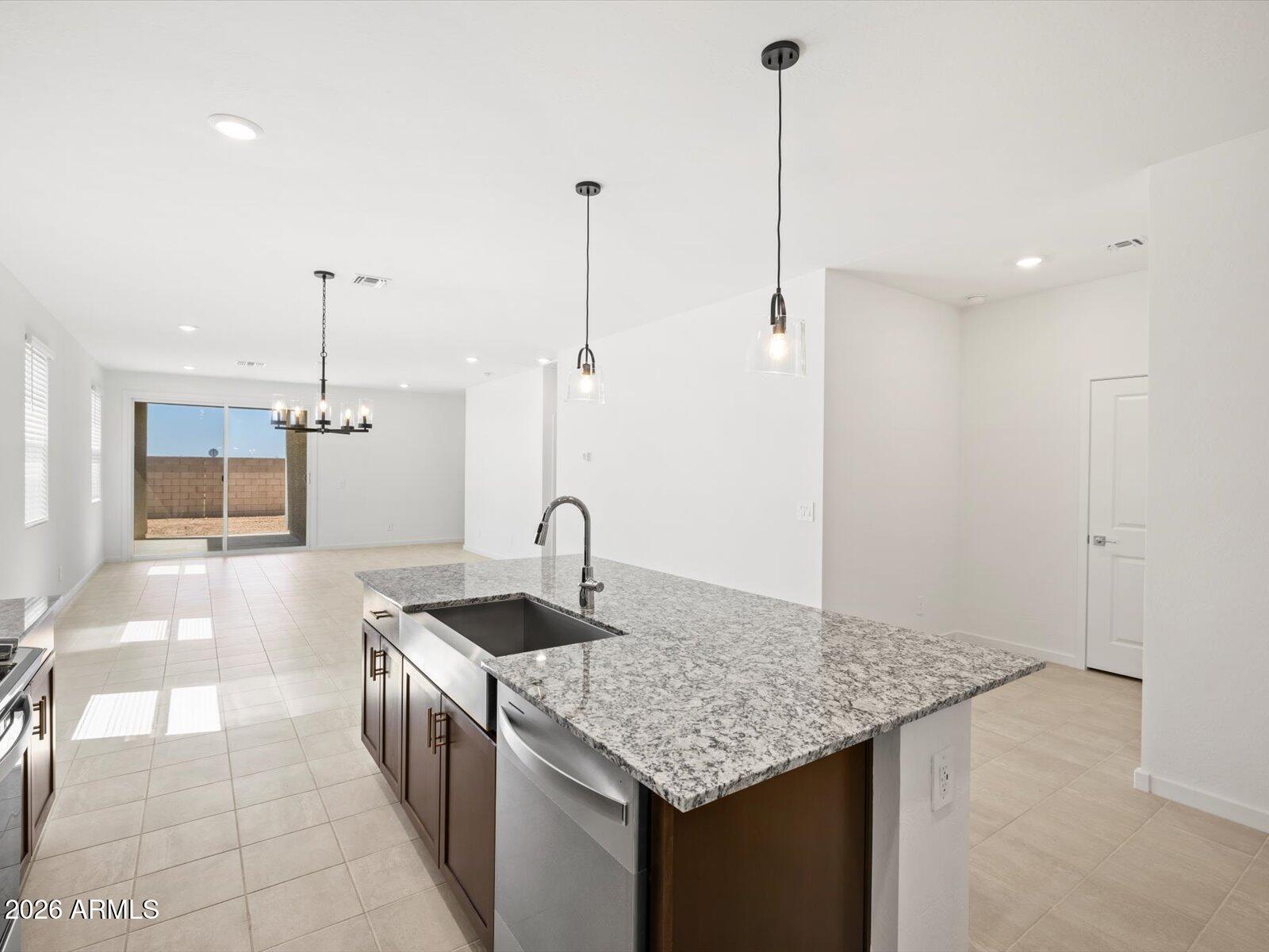 8936 South 244th Lane Buckeye, AZ 85326 - Photo 44 of 45 a kitchen with kitchen island a counter top space appliances and a counter top