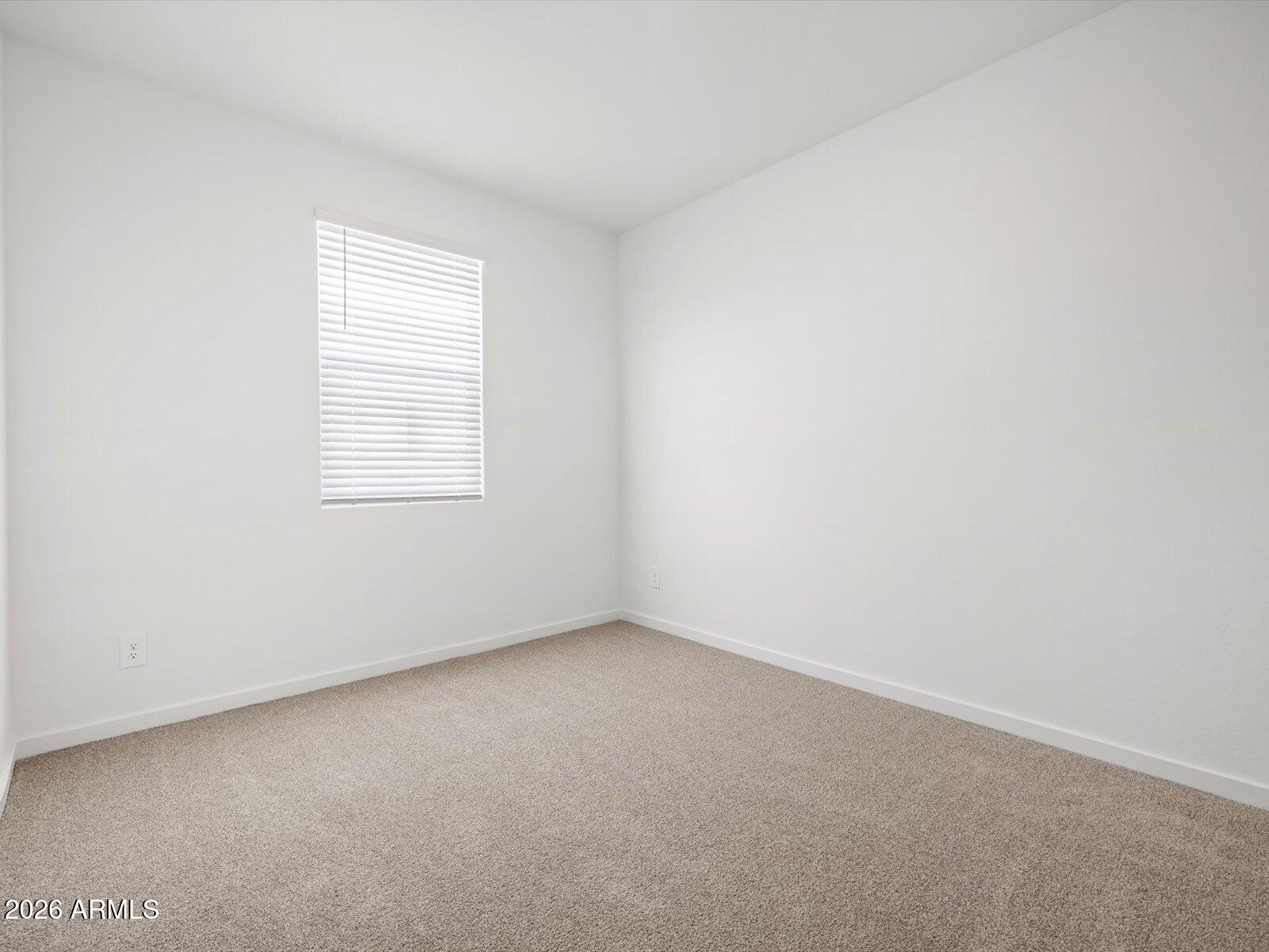 8936 South 244th Lane Buckeye, AZ 85326 - Photo 4 of 45 an empty room with a window