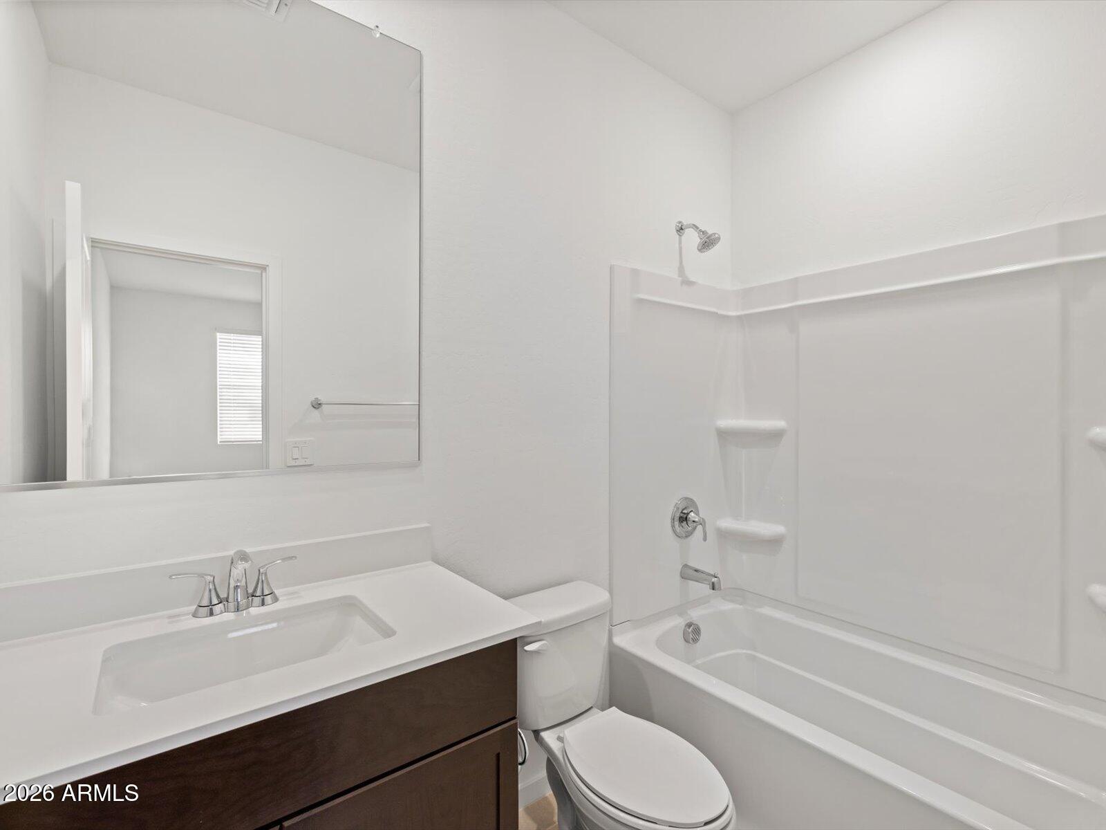 8936 South 244th Lane Buckeye, AZ 85326 - Photo 6 of 45 a bathroom with a sink a toilet and shower